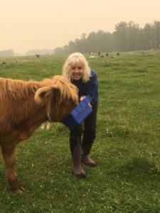 Shannon Laackmann and her Highland Cow